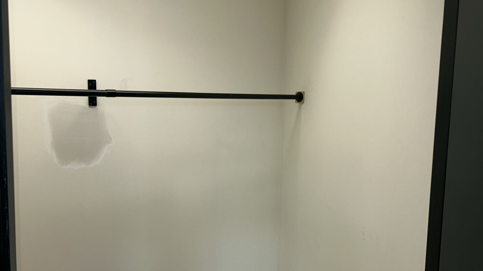 Cloakroom with black wall-mounted coat rail